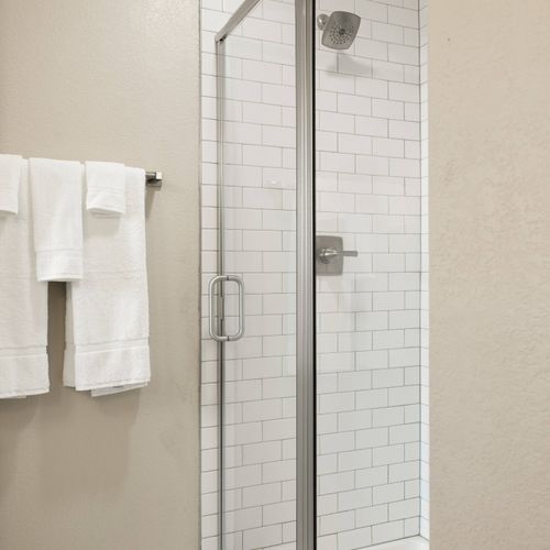 Glass shower in primary en suite bathroom