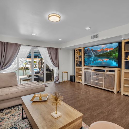 Welcome to your cozy-chic retreat! This bright, modern space features a comfy sectional, stylish decor, and a large smart TV—perfect for relaxing. Slide open the doors to a private patio and unwind in comfort and style.