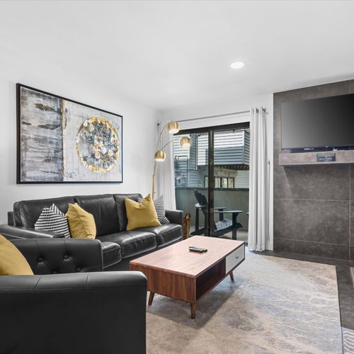 Living area with queen sleeper sofa, patio, TV, and gas firepalce