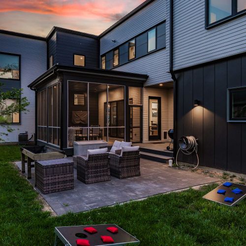 Our backyard features outdoor seating, a grill, and cornhole ready for you to play your next match!