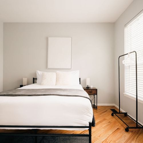 Sleeping area off of the living room with a queen bed