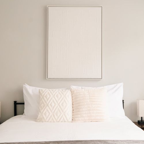 The office has been converted to a sleeping area with a queen bed