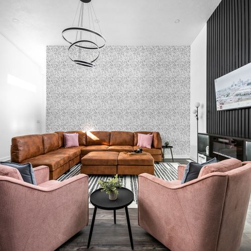 Cozy up in the living room with a roomy sectional, 2 stylish chairs, smart TV, and bold Indianapolis style—perfect for 6 to hang out.