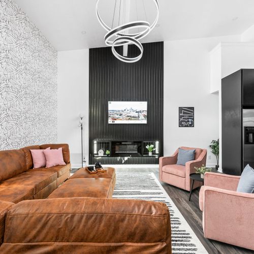 Cozy up in the living room with a roomy sectional, 2 stylish chairs, smart TV, and bold Indianapolis style—perfect for 6 to hang out.