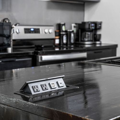 Hidden outlets and USB ports pop up right from the countertop—perfect for charging and powering all your appliances!