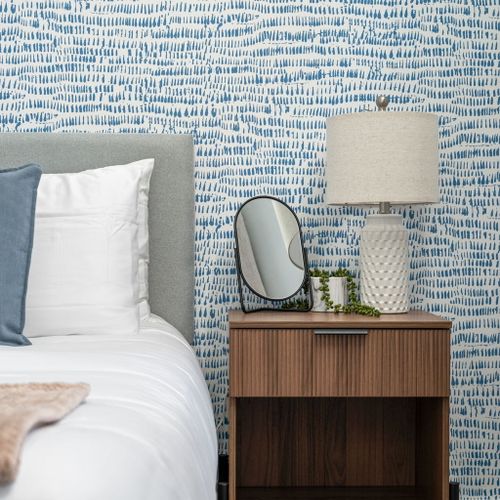 Simple touches, cool blues, and cozy vibes—your perfect nightstand setup.