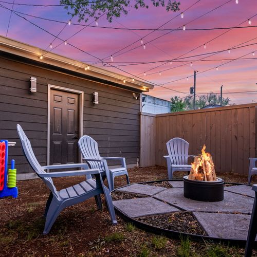 Kick back in the backyard by the modern stainless steel fire pit, string lights, chairs, games, and grill—outdoor vibes done right, plus easy access to the one-car garage!