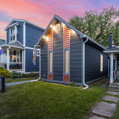 Modern vibes from the curb — dark siding, wood accents, and a bold house number that makes a statement, can’t forget our Indianapolis Motor Speedway flag!