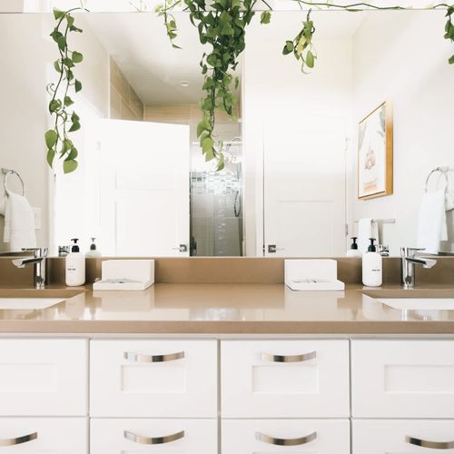 Primary bedroom's full ensuite private bathroom with dual vanities