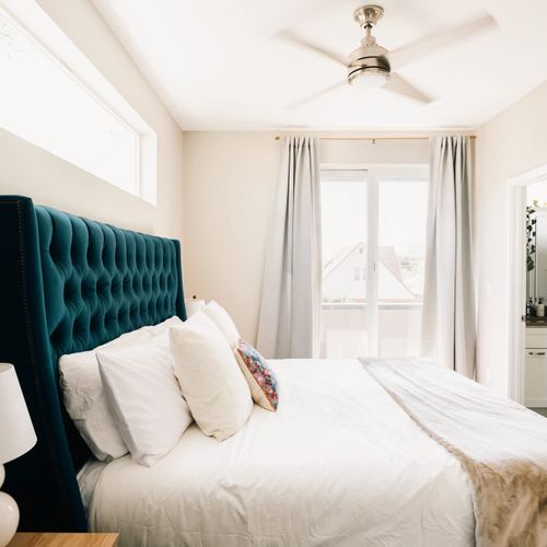 Primary bedroom with king bed and balcony