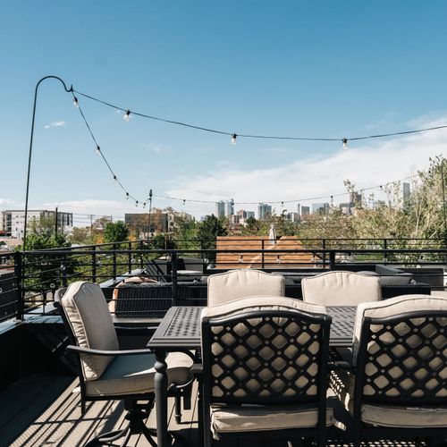 Rooftop deck dining area with a Denver skyline view