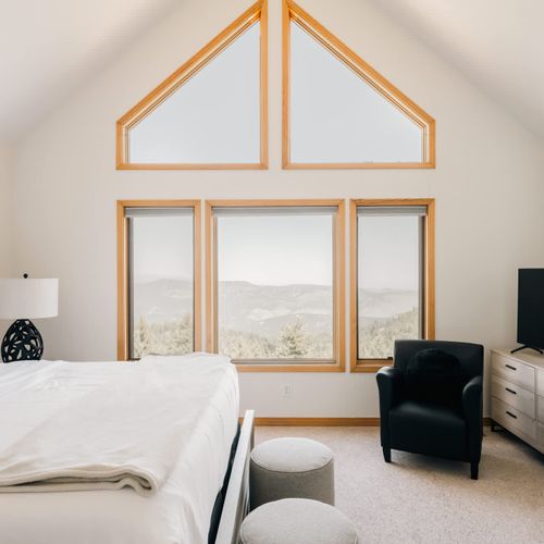 Primary bedroom with king bed, smart TV, and gas fireplace