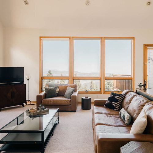 Main level living room with comfy couches and a grand view