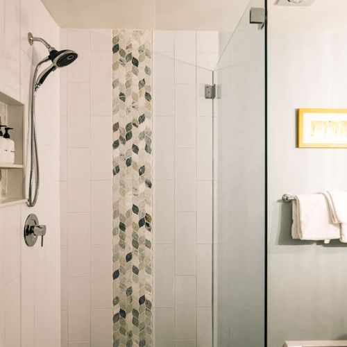 Primary bedroom's full ensuite bathroom with walk-in glass shower