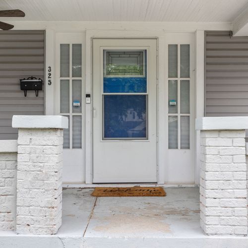 Welcoming front porch with classic charm and keyless entry for easy self check-in!