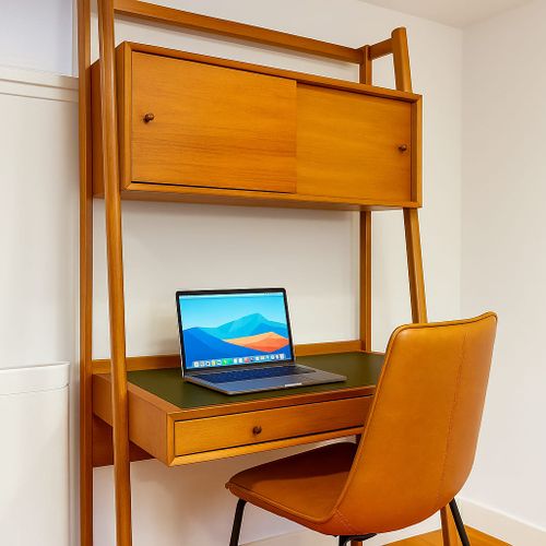 Work remotely or take a video call. Tucked-away desk with outlets and good light.