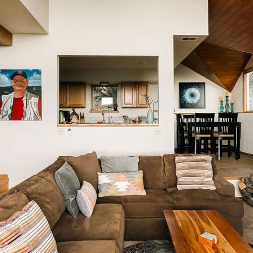 Main level with living area, kitchen, and dining table