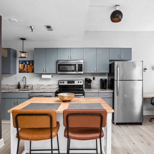 Modern meets inviting in this thoughtfully designed kitchen — complete with sleek stainless steel appliances, warm wood accents, and a stylish island perfect for dining or sipping your morning coffee.