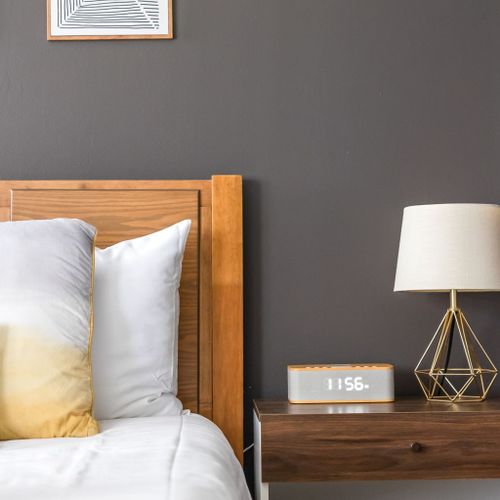 Thoughtful touches for a restful stay — this cozy bedside table features a soft-glow lamp and easy-to-read digital clock, perfect for winding down at night or easing into your morning. Comfort, convenience, and style right at your bedside.