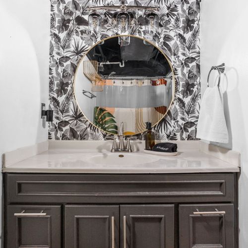 Simple, stylish, and refreshingly modern — this round mirror paired with a sleek bathroom sink adds just the right touch of elegance. Perfectly lit and thoughtfully designed, it’s the ideal space to refresh and unwind.