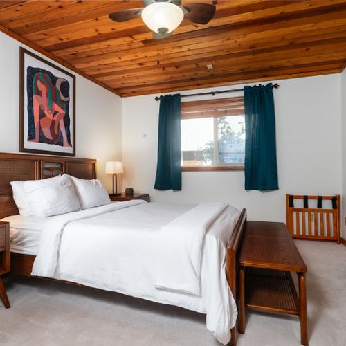 Primary bedroom: Queen bed with windows on both sides.
