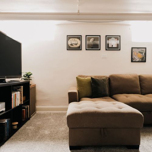 Downstairs living area with large Smart TV and Sonos speaker