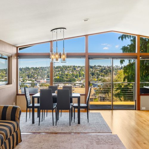 Light-filled living space with large windows and a cozy atmosphere.