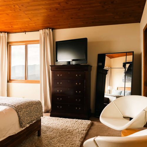 Primary bedroom with a flatscreen TV and full, private, ensuite bathroom