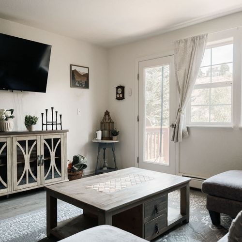 Living area with smart TV and balcony exit