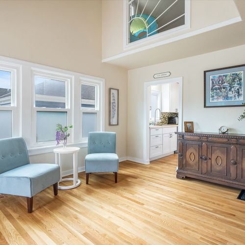 Light-filled living room with fireplace + Smart TV for cozy nights in.