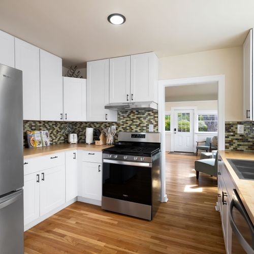 Sleek, fully equipped kitchen with stainless appliances.