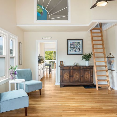 Spacious lounge with open flow to dining and deck + ladder to the kids loft / play area.
