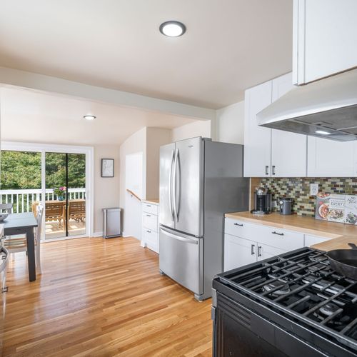 Bright kitchen with easy deck access for indoor-outdoor dining.