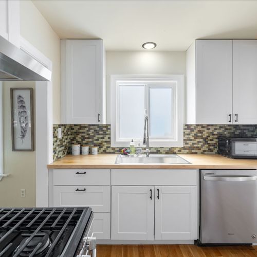 Sleek, fully equipped kitchen with stainless appliances.
