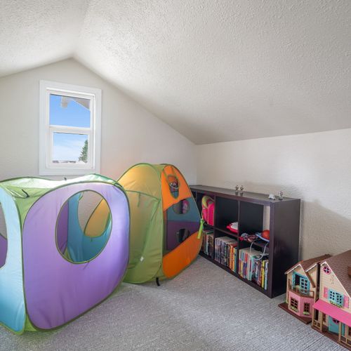 Kids’ loft playroom — books, toys, and space to explore.