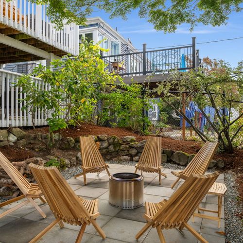 Backyard fire pit with Adirondack seating — gather for s’mores and stories under the stars.
