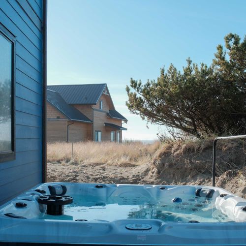 Take in the sea air in your private hot tub.