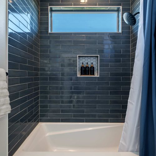 Bathroom 3 of 3 - Downstairs with bright finishes and storage space.