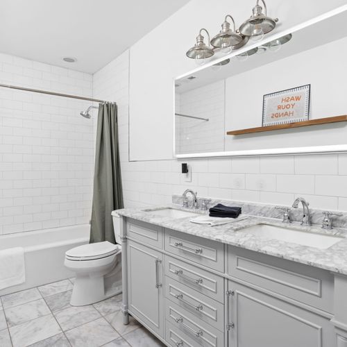 Ensuite bathroom to our green bedroom, with a modern double vanity, and sleek finishes!