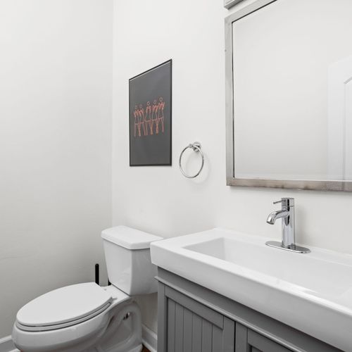 Take your next selfie in our modern half bath located just off the living area!