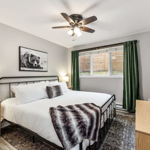 Primary bedroom with king bed and flat-screen TV