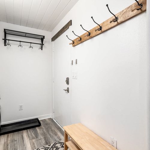 Entryway with closet and coat storage