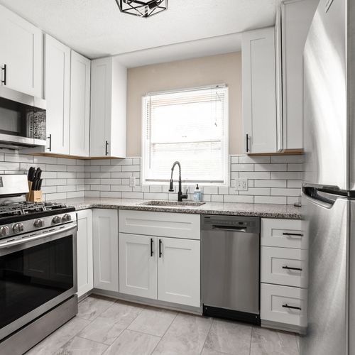 Modern kitchen with stainless steel appliances, subway tile backsplash and all of the necessities for your stay!