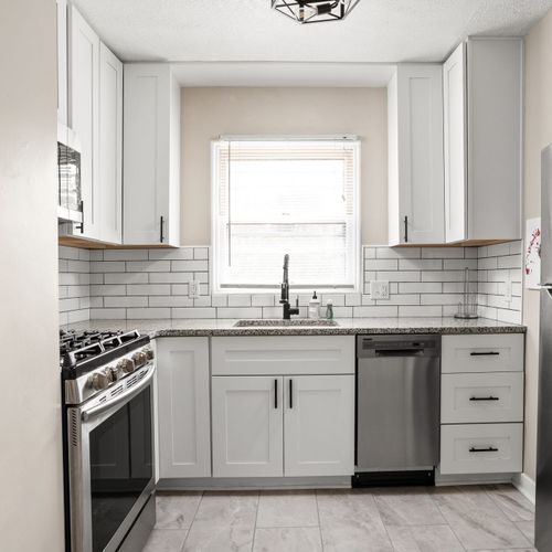 Modern kitchen with stainless steel appliances, subway tile backsplash and all of the necessities for your stay!