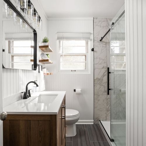 Our full bathroom, with a modern vanity, tiled standing shower, and all the essentials for a perfect stay!