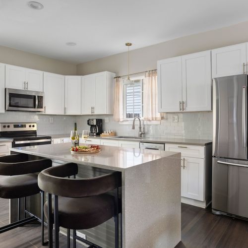 Gather around the island — your home base for coffee, cocktails, or dinner prep.