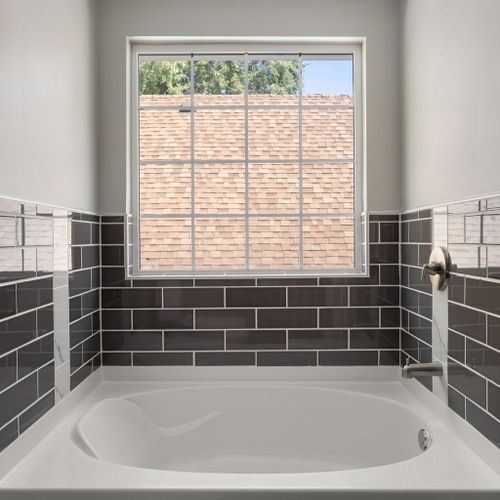 Bright, spa-like tub perfect for a quiet moment of relaxation.