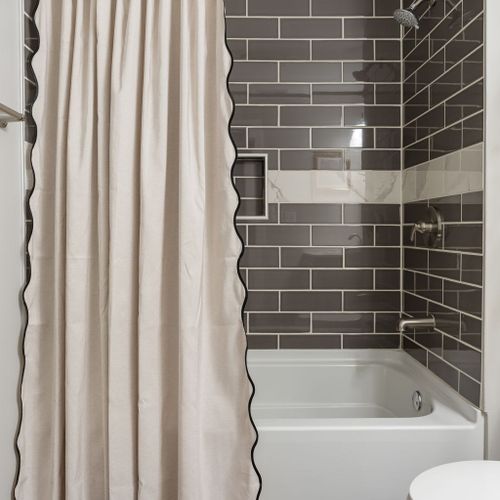 Beautifully tiled shower-tub combo designed for comfort and style.