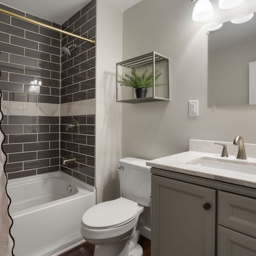 Bright and stylish — a full bath perfect for guests.