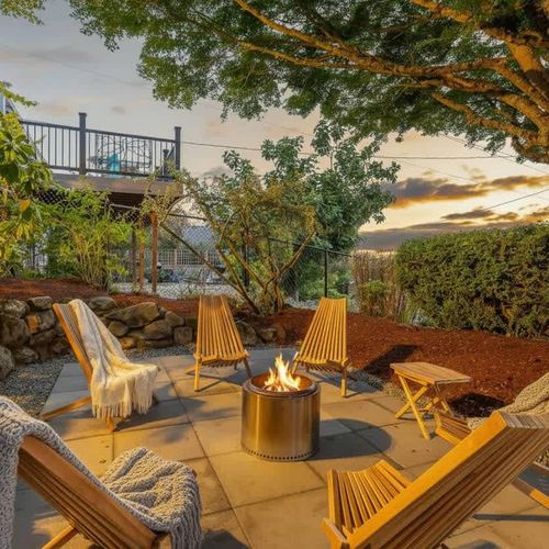 Evening glow from the backyard fire pit area, tucked into the trees.